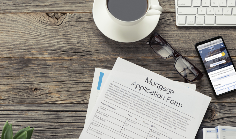 Mortgage application form on wooden table.